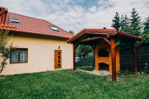 a house with a pavilion in the yard at Casa Roland in Gheorgheni
