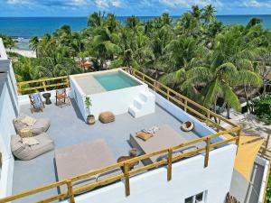 a balcony with a swimming pool and the beach at Casa Alkimia Town in Isla Mujeres