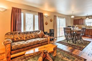 a living room with a couch and a table at Drake Home on Big Thompson River - 3 Mi to Estes! in Estes Park