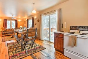 a kitchen and living room with a table and a stove at Drake Home on Big Thompson River - 3 Mi to Estes! in Estes Park