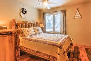a bedroom with a wooden bed with a window at Drake Home on Big Thompson River - 3 Mi to Estes! in Estes Park