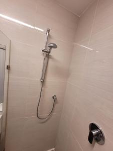 a shower in a bathroom with a tiled wall at The Oceanic in Durban
