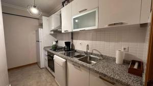 a kitchen with a sink and a counter top at Прекрасная двухуровневая квартира с террасой in Istanbul