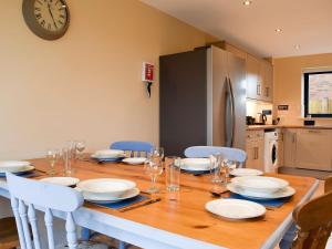 a dining room table with plates and glasses on it at Woodland View - Ukc3893 in Coton in the Elms