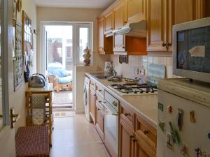a kitchen with a sink and a stove top oven at Scotties Retreat in Wrafton