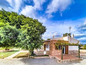 a house with a tree in front of it at Can Pep Yern 1 in Playa Migjorn