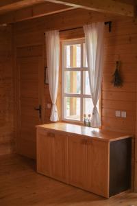 a large window in a room with a large kitchen at Holiday Homes Vita Natura in Rakovica