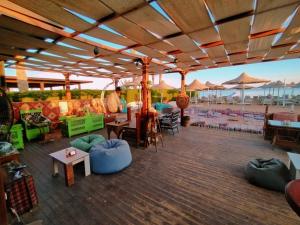 a patio with tables and chairs and umbrellas at Tow bedroom flat at Muntazah Sharm Elshikh in Sharm El Sheikh
