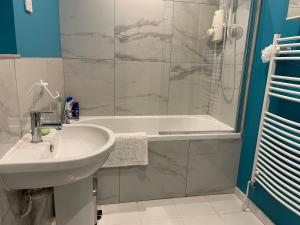 a bathroom with a sink and a shower and a tub at Silver Lodge in Mildenhall