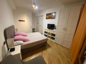 a small bedroom with a bed and a desk at B&B La Piazzetta della Pioggia in Bologna