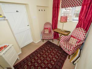een kamer met 2 stoelen en een tafel en een deur bij Cobble Cottage30c - Ukc2846 in Blakeney