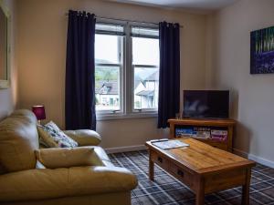 a living room with a couch and a coffee table at Beechwood in Arrochar