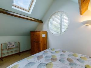 a bedroom with a bed and a window at Acorn Cottage in Knutsford