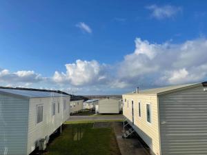 a row of mobile homes parked next to each other at Lexi Lodge @ Littlesea Holiday Park, Weymouth in Wyke Regis