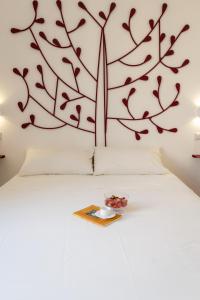 a bedroom with a large tree mural on the wall at La Casa Di Iulia in Rome