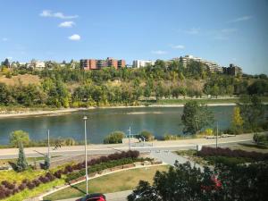 a view of a river with a city in the background at Amicable, Cozy, High Speed Internet, Sleeps 2 Riverview Downtown Apartment in Calgary