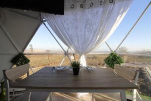 a wooden table with a view of a field at Heart Of The Hills in Golan Heights