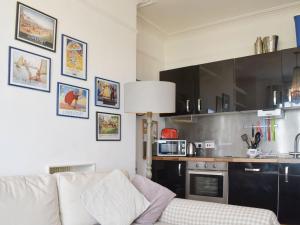 a living room with a couch and a kitchen at Flat 3 Sea View - Ukc4219 in Lowestoft