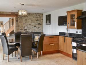 a kitchen with a dining room table and chairs at The Farm House in Wolsingham