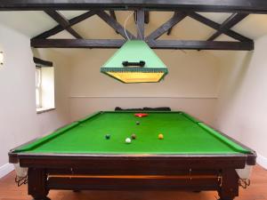 a pool table with balls on it in a room at The Farm House in Wolsingham