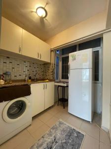 a kitchen with a washer and a white refrigerator at Taksim house in Istanbul