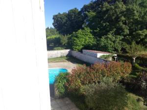 a view of a swimming pool in a garden at Hébergement 4 personnes Lencouacq in Lencouacq
