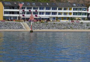 a large building next to a body of water at Hotel Hochseeinsel in Helgoland