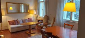a living room with a couch and a table at Belladonna Panorama Apartment in Bad Gastein