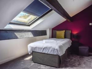 a bedroom with a bed in a attic at Bridge House in Holmfirth