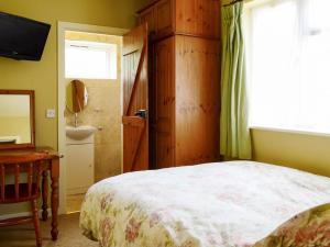 a bedroom with a bed and a sink and a window at Oakdene Lodge in Saint Leonards