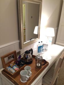 a bathroom counter with a sink and a mirror at Trearddur Bay Hotel in Trearddur