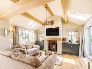 a living room with a couch and a fireplace at Drake Cottage in Wilsden