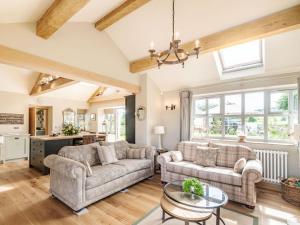 a living room with two couches and a table at Drake Cottage in Wilsden