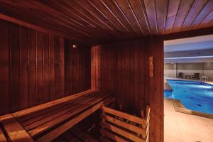 a wooden room with a swimming pool with a wooden tub at Maristel Hotel & Spa - Adults Only in Estellencs