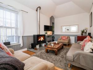 a living room with a couch and a fireplace at Ebenezer Chapel in Saxmundham