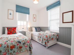 a bedroom with two beds and a window at Ebenezer Chapel in Saxmundham