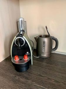 a toaster and a coffee maker on a counter at Premium Casa Apartman in Sopron