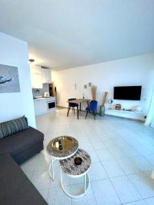 a living room with a couch and a table at Ocean Kiss Apartment in Puerto del Carmen +8 photos