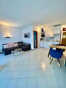 a living room with a couch and a table at Ocean Kiss Apartment in Puerto del Carmen