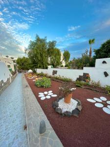 a garden with a vase in the middle of a yard at Ocean Kiss Apartment in Puerto del Carmen