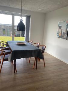 a dining room with a black table and chairs at Nyt hus in Herning