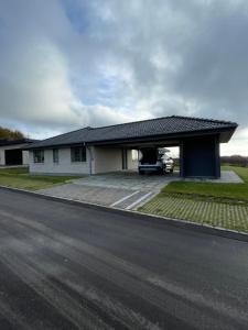 a house with a car parked in the garage at Nyt hus in Herning