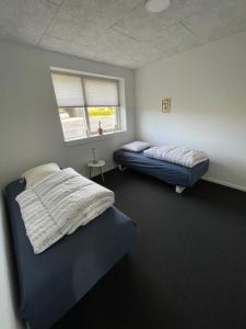 a bedroom with two beds and a window in it at Nyt hus in Herning