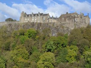 a castle on top of a hill with trees at Easter Baldinnies in Forteviot