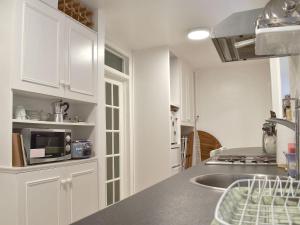 a kitchen with white cabinets and a counter top at Flat 1 Garden View - Ukc4221 in Lowestoft