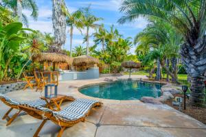 a swimming pool with two lounge chairs and a resort at Moonlight Cove in Encinitas