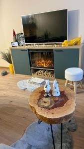 a living room with a table and a fireplace at The Green apartment in Borovets