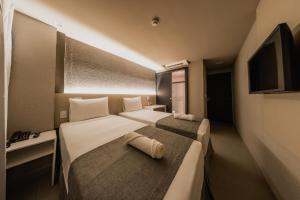 Postel nebo postele na pokoji v ubytování Saint Patrick Grand Hotel