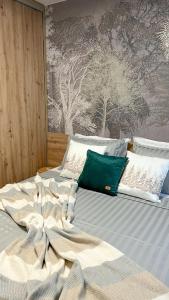 a bed with a blanket on top of it at The Green apartment in Borovets