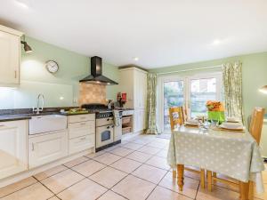 a kitchen with a table with a table cloth on it at Laurel Villa in Cheltenham